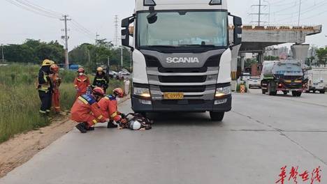 女子驾驶电动自行车被卷进货车底下，消防紧急救援