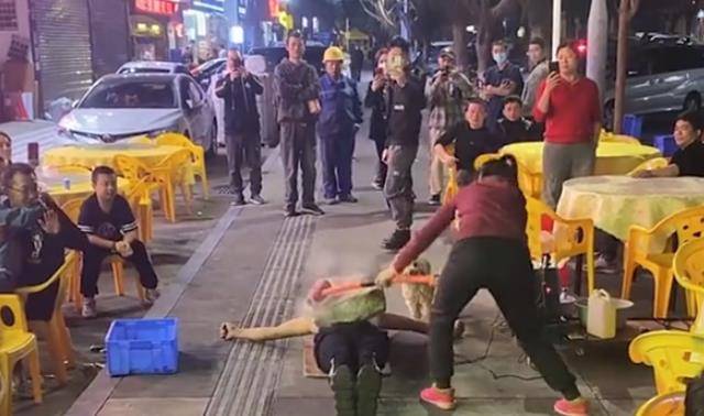 夫妻夜晚街头卖艺,表演胸口碎大石,铁锤都砸出了火花