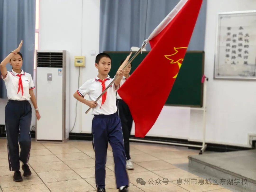 主持人宣布仪式开始,伴随着雄壮激昂的出旗曲,护旗手护卫着鲜艳的队旗